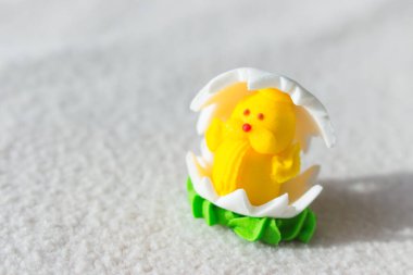 Easter chicken candy on white background. Easter decoration. Springtime holidays. Decorative sweets. Easter chicken in egg. Sugar handmade dessert. Happy Easter symbol. 