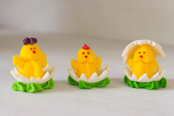 Easter chicken candy on white background. Easter decoration. Springtime holidays. Decorative sweets. Easter chicken in egg. Sugar handmade dessert. Happy Easter symbol.