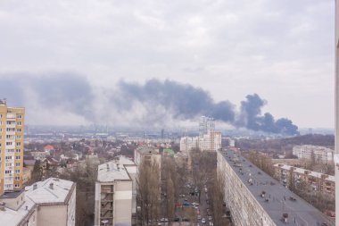 Black smoke from explosion in Kyiv, Ukraine. Russian invasion to Ukraine. Missile attack in Kyiv. Kyiv cityscape, view rom window. War in Ukraine. Russian agression in Ukraine.