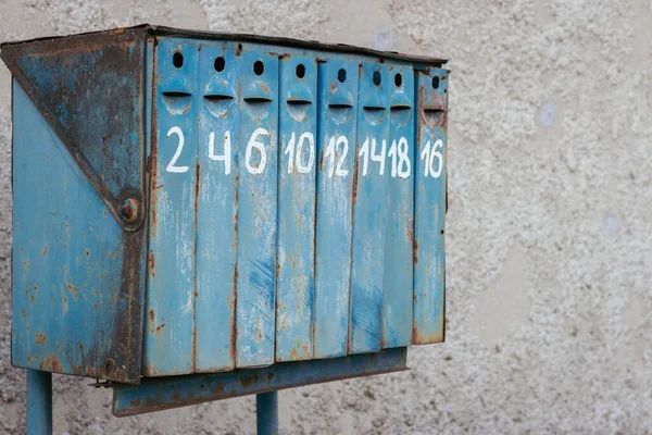 Old fashioned mail box. Row of blue postbox. Letter box with numbers. Retro postal storage. Outdoor mailbox. Private correspondence. Mail container. Mail delivery.
