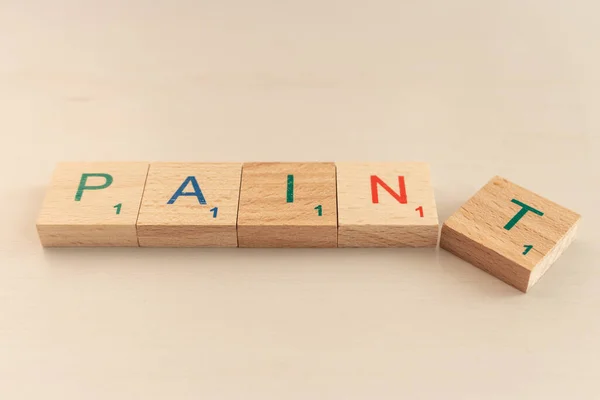 Word pain and paint in wooden cubes. Choice concept. Word paint in letters. Negative or positive. Alphabet in wooden blocks. Creative design. Colourful letters on cubes.