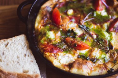 Tavada domates ve jambonlu sahanda yumurta. Kahvaltı masası servisi. Domates ve ekmekle omlet. İspanyol tortilla 'sı. Pesto ve sebzeli yumurta. Yemek yemeye hazır. Sağlıklı yemek.. 