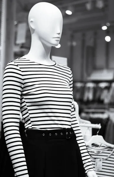 Mannequin in shop, black and white. New fashion collection, monochrome. Mannequin in shopping mall. Woman clothing on the dolls. Outfit concept. Dolls in show window. Retail store design.  Fashionable lifestyles.