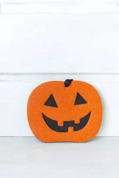 Halloween pumpkin on white background with copy space. Halloween decoration. Trick or treat. Traditional October still life. Scary pumpkin. Halloween symbol. Autumn interior decor. Scary pumpkin face.