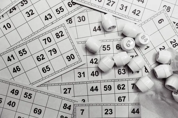 Playing lotto game, monochrome. Dices with figure on bingo card background, black and white. Nostalgia lifestyle. Table games. Retro games. Barrel with number and paper cards for bingo game. Holiday leisure. Luck concept. Vintage games.