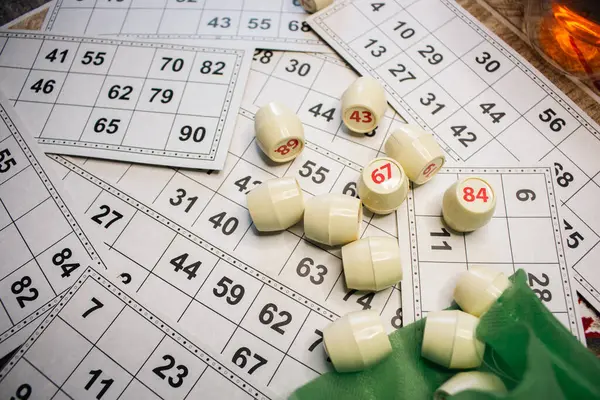 Playing lotto game. Cubes with figure on bingo card background. Nostalgia lifestyle. Table games. Retro games. Barrel with number and paper cards for bingo game. Holiday leisure. Luck concept. Vintage games.