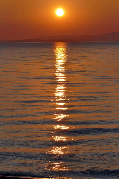 sunset over the sea with sun reflection on water