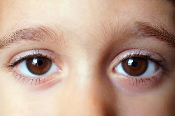 Sad eyes of 4 years old girl, close up