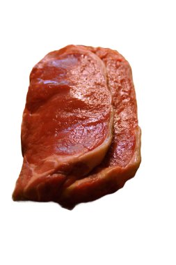 A generous cut of ribeye steak, beautifully marbled, rests on a rustic wooden board. The tender fibers and deep color of the meat highlight the richness of this premium cut, poised to deliver full flavor.