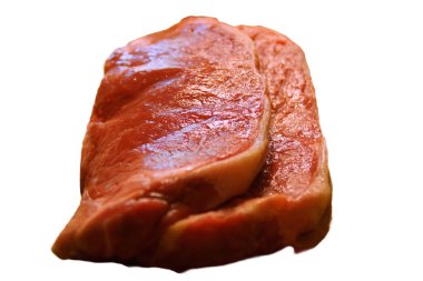 A generous cut of ribeye steak, beautifully marbled, rests on a rustic wooden board. The tender fibers and deep color of the meat highlight the richness of this premium cut, poised to deliver full flavor.