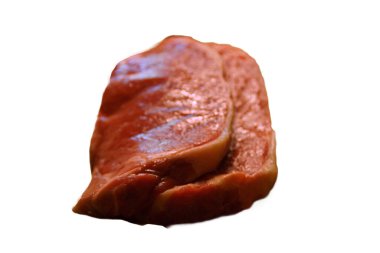 A generous cut of ribeye steak, beautifully marbled, rests on a rustic wooden board. The tender fibers and deep color of the meat highlight the richness of this premium cut, poised to deliver full flavor.