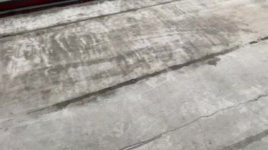 Construction works. 4k video footage with priming the floor surface before further finishing work. The builder is priming the floor with a roller
