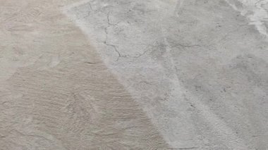 Construction works. The builder removes dust and small debris from the surface of the cement-sand screed using a vacuum cleaner for further finishing work. 4k video footage
