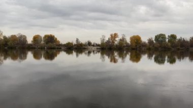 Footage shot in slow motion on the river in autumn. The flow of water on the background of nature