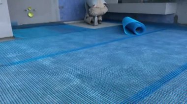 4k video footage of laying reinforcing nylon mesh on the floor. Construction works