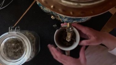 Boiling a samovar in a sauna, a bath for making fragrant herbal tea. Traditional tea after steaming in the sauna