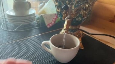 Boiling a samovar in a sauna, a bath for making fragrant herbal tea. Traditional tea after steaming in the sauna
