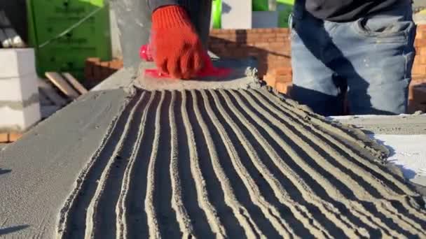 Male Builder Lays Foam Block Special Mortar Laying Blocks Outer — Stockvideo