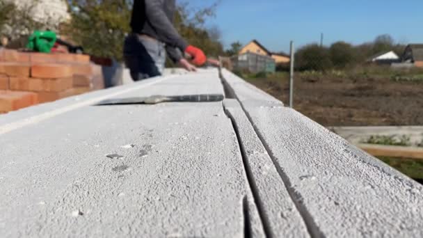 Video Footage Male Builder Removing Pieces Foam Block Cut Strobe — Stockvideo