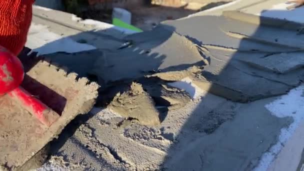Male Builder Lays Foam Block Special Mortar Laying Blocks Outer — Stockvideo