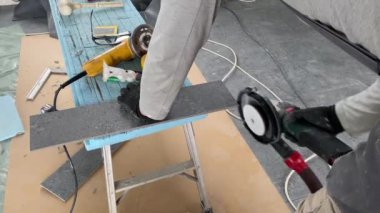 4k video footage of taking measurements for further cutting tiles using a diamond cutter. Laying tiles by a professional tiler in a modern interior.