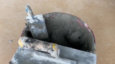 4k video footage of laying a large wide-format tile on a mounting mortar. Tiler laying tiles on cement mortar for gluing tiles on a surface with a floor heating system