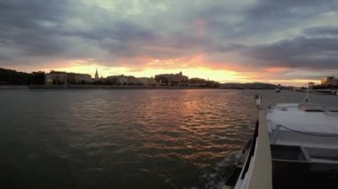 Macaristan 'ın başkenti Budapeşte' de Tuna Nehri boyunca bir nehir yürüyüşünün 4k video görüntüsü. Nehirde bir zevk gemisinde yelken açmak