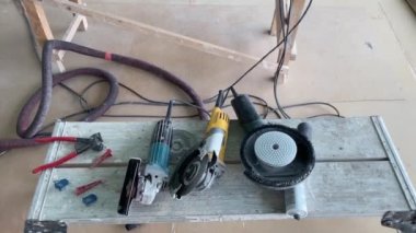 4k video footage of taking measurements for further cutting tiles using a diamond cutter. Laying tiles by a professional tiler in a modern interior.