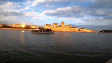 4k video footage of The Parliament building in Budapest at sunset from a sightseeing tour of the river on a boat, Hungary