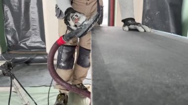 Tiling work. 4k video footage of grinding cuts at 45 degrees in tiles. Builder tiler cuts a large porcelain stoneware tile with a grinder