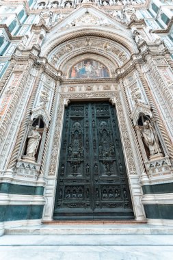 Detail of the facade of the Cathedral of Santa Maria del Fiore in Florence in the middle of the day, Italy