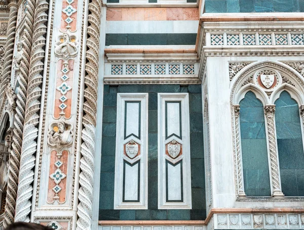 Detail of the facade of the Cathedral of Santa Maria del Fiore in Florence in the middle of the day, Italy