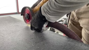 4k video footage of taking measurements for further cutting tiles using a diamond cutter. Laying tiles by a professional tiler in a modern interior.