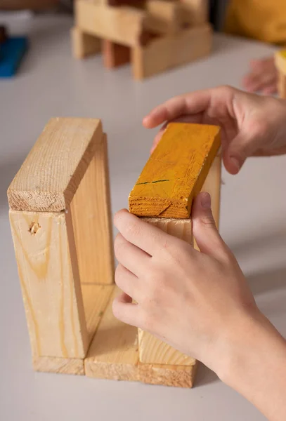 Wood bricks a child game, kids hands constructing