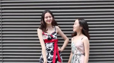 Asian happy women portrait wearing dresses posing on the street 