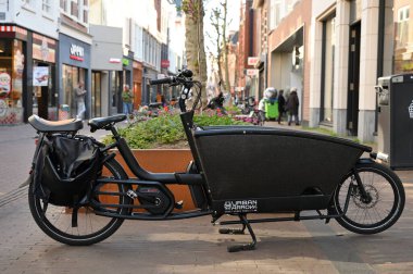 Haarlem, Netherlands - April 21, 2022: Cargo Bicycle With Long Bucket at street. Haarlem is a city and municipality in the Netherlands clipart