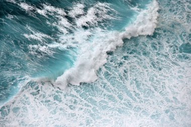 Turquoise ocean water background. View from above to the waves of the ocean