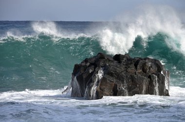 Large Atlantic Ocean wave crashing in to the volcanic rock, Madeira island