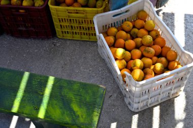Orange fruits - large amounts of orange fruits, fresh orange fruits, orange fruits in a plastic baskets, Greece