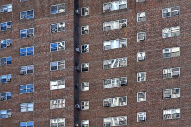 New York City - February 14: air conditioners on house facade in Manhattan on February 14, 2023 in New York City, NY. Manhattan is the most densely populated borough of New York City.