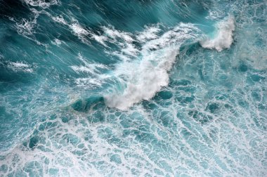 Turquoise ocean water background. View from above to the waves of the ocean