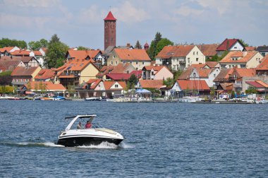 Mikolajki, Poland, May 14: View to city from the lake on May 14, 2023 at Mikolajki, Poland. Mikolajki is a resort town in the Warmian-Masurian Voivodeship in north-eastern Poland. clipart