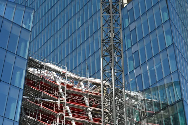建筑起重机和高层建筑的施工 建筑工地玻璃立面 起重机现代混凝土建筑的城市景观设计 — 图库照片