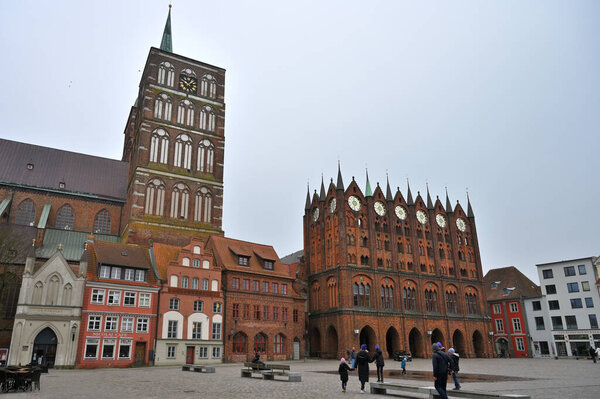 Stralsund, Germany - April 14, 2023: unidentified people in Old market square of Stralsund. The historic Stralsund old town island is a UNESCO World Heritage Site