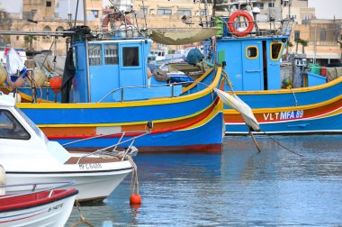 Marsaxlokk, Malta, 2023 December 24: Fisherman boats. Traditional eyed colorful boats Luzzu in the Harbor of Mediterranean fishing village Marsaxlokk, Malta clipart