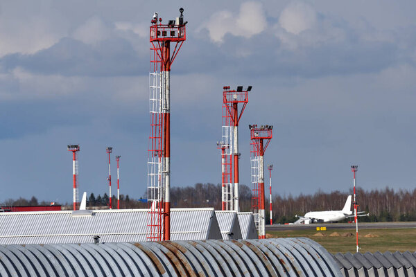 Airport in Vilnius. Antenna tower with satellite dishes, airport infrastructure.