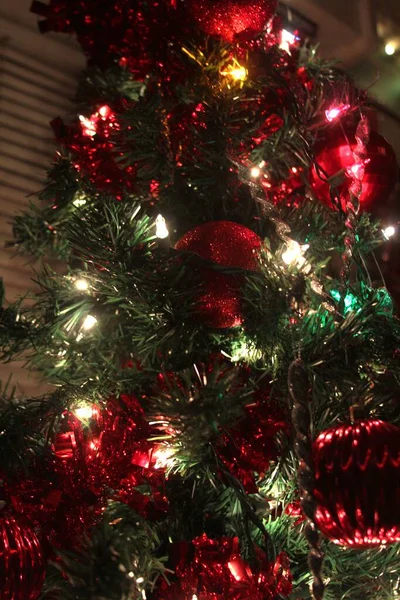 Red and green decorations with Christmas lights on the Christmas Tree