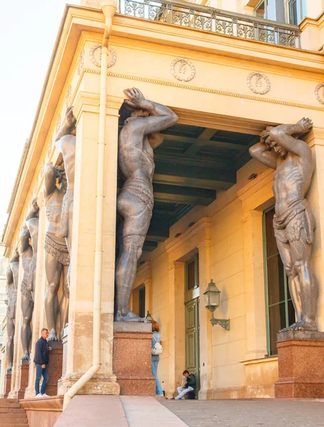 Granite stone statues of Atlantes at the entrance to the new Hermitage in the northern capital of Russia, St. Petersburg. A famous tourist attraction all over the world. The place is often rented in
