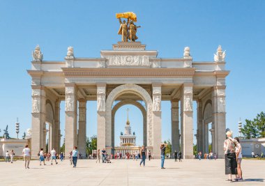 Park VDNH, Moscow city architecture of Soviet period. VDNKh, Exhibition of Achievements of National Economy, flower bed and building of entrance or gate. All Russian Exhibition Center