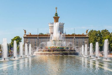 MOSCOW, RUSSIA - JUNE 17, 2021: Fountain in VDNKh park in Moscow. Sunny view of the Soviet architecture, landmark of Moscow. Famous touristic place